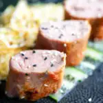 Honey and miso glazed pork tenderloin with sesame seeds.