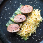 Overhead honey and miso glazed pork tenderloin with sesame seeds.