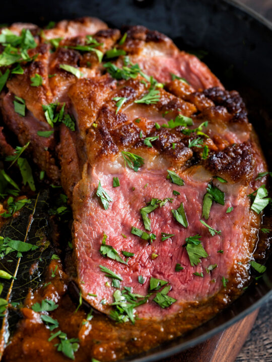 Close up Indian duck breast curry served in an iron karai.