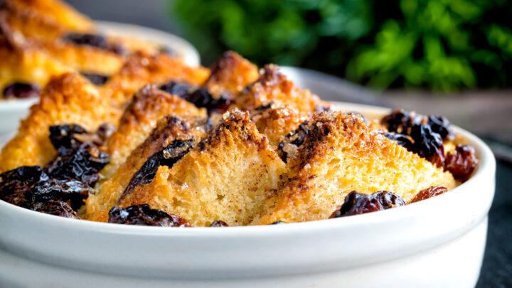 Close up individual bread and butter pudding served in a single serving bowl.