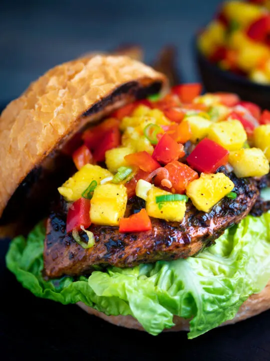 Jamaican jerk chicken burger with a mango salsa served on a toasted bun.