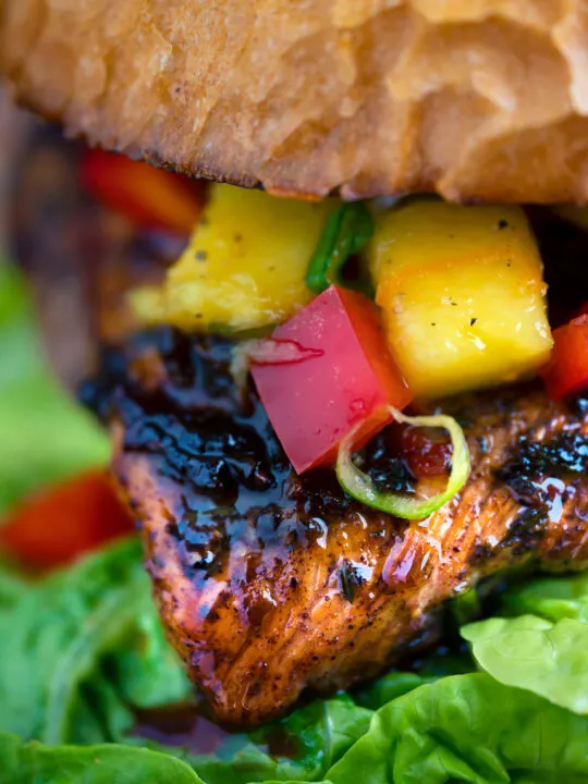 Close up Jamaican jerk chicken burger with a mango salsa.