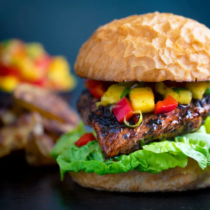 Jamaican jerk chicken burger with a mango salsa & potato wedges.