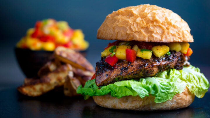 Jamaican jerk chicken burger with a mango salsa & potato wedges.