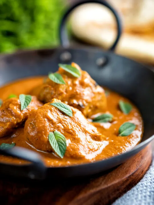 Indian lamb tikka masala curry served with a naan bread.