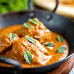 Indian lamb tikka masala curry served with a naan bread featuring a title overlay.