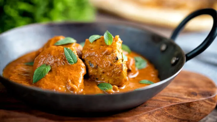 Indian lamb tikka masala curry served peppermint leaves.