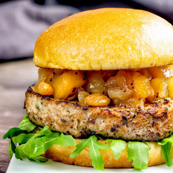 Pork and apple burgers served with rocket and apple chutney served on a bun.