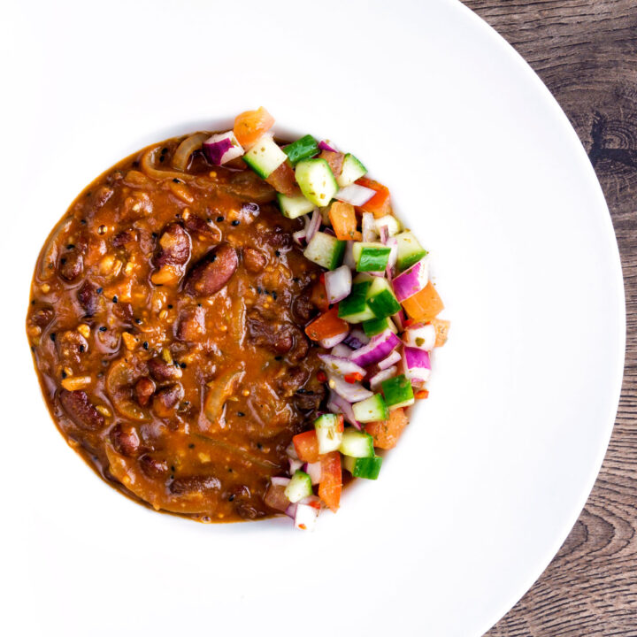 Indian vegan rajma masala kidney bean curry served with kachumber salad.