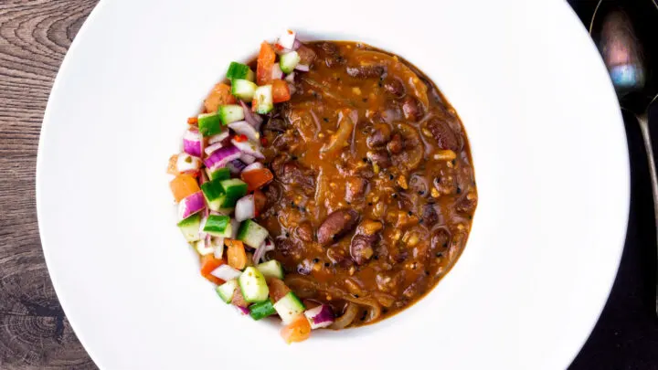 Indian vegan rajma masala kidney bean curry served with kachumber salad.