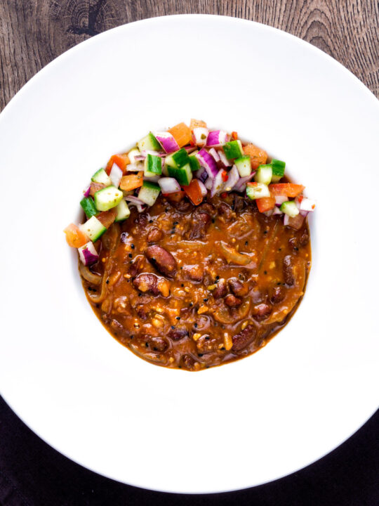 Overhead Rajma masala kidney bean curry served with kachumber salad.