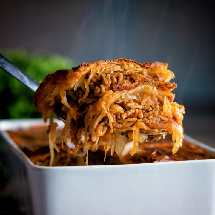 Baked rakott kaposzta, Hungarian sauerkraut casserole spooned from a casserole dish.