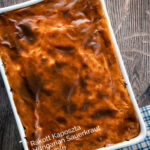 Overhead rakott kaposzta, Hungarian sauerkraut casserole in a casserole dish featuring a title overlay.