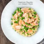 Overhead salmon risotto with green peas and fennel seeds featuring a title overlay.