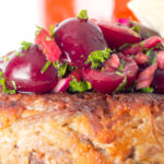 Close up of cherry salsa sat on a shredded duck burgers.