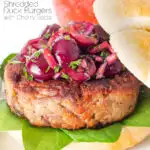 Shredded duck burgers topped with cherry salsa featuring a title overlay.
