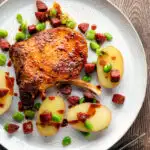 Overhead Spanish pork chops with chorizo sausage, broad beans and potatoes.