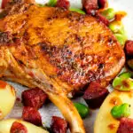 Close up Spanish pork chops with chorizo sausage, broad beans and potatoes.