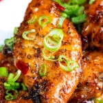 Sticky spicy Thai inspired chicken wings with green onion.