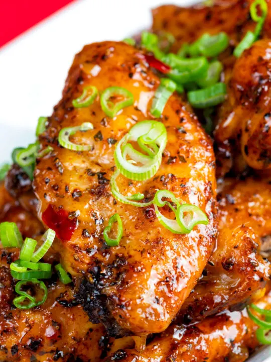 Sticky spicy Thai inspired chicken wings with green onion.