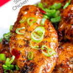 Sticky spicy Thai inspired chicken wings with green onion featuring a title overlay.