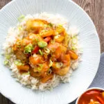 Overhead crispy sweet and sour pork balls served with rice.