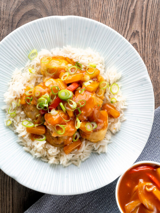 Overhead crispy sweet and sour pork balls served with rice.