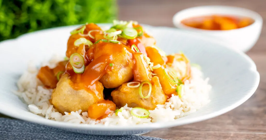 Crispy Chinese sweet and sour pork balls served with white rice.