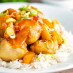 Crispy Chinese pork balls swerved with sweet and sour sauce on rice.
