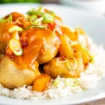 Crispy Chinese pork balls swerved with sweet and sour sauce on rice.