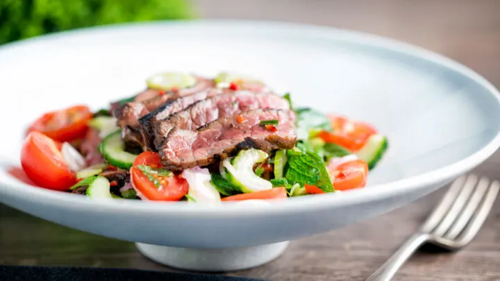 Spicy Thai beef salad with rare beef, tomatoes, mint, chilli, shallot, celery and cucumber.