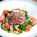 Thai beef salad with rare beef, tomatoes, mint, chilli, shallot, celery and cucumber.