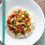 Overhead Thai cashew chicken stir fry served on steamed rice.