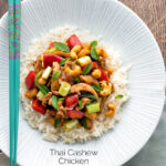 Overhead Thai cashew chicken stir fry served on steamed rice featuring a title overlay.