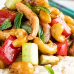 Close up Thai cashew chicken stir fry served on steamed rice.
