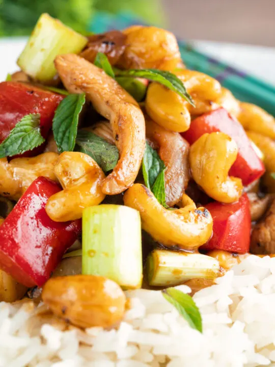 Close up Thai cashew chicken stir fry served on steamed rice.