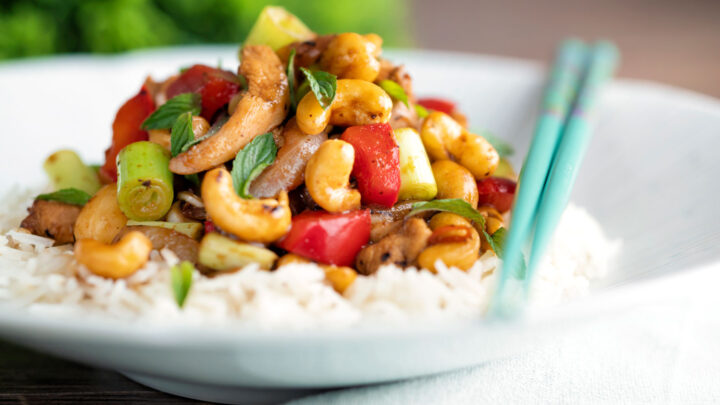 Thai cashew chicken stir fry with red peppers and thai basil served on steamed rice.