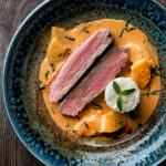 Overhead Thai red duck curry with pineapple, rice and Thai basil.