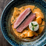 Overhead Thai red duck curry with pineapple, rice and Thai basil featuring a title overlay.