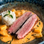 Thai red duck curry with pineapple, rice and Thai basil.