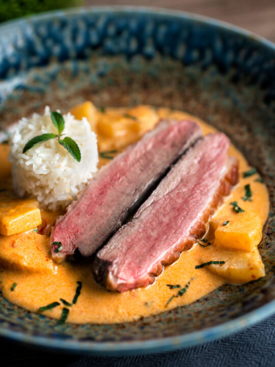 Thai red duck curry with pineapple, rice and Thai basil.