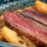 Close up Thai red duck curry with pineapple, rice and Thai basil.