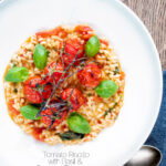 Overhead tomato risotto with basil and roasted tomatoes featuring a title overlay.