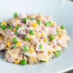 Tuna pasta salad with peas, corn and red onion.