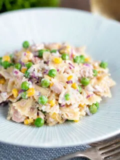 Tuna pasta salad with peas, corn and red onion.
