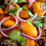 Close up Indian butter bean curry served with a naan bread featuring a title overlay.