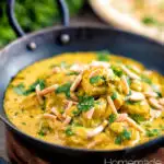 Chicken korma curry garnished with coriander and almonds featuring a title overlay.