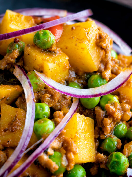 Close up minced beef curry with peas and potatoes.