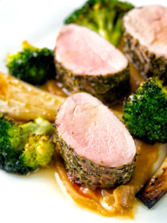 Roast pork fillet served with apple puree, roast parsnips and broccoli.