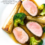 Overhead roast pork fillet served with apple puree, roast parsnips and broccoli featuring a title overlay.